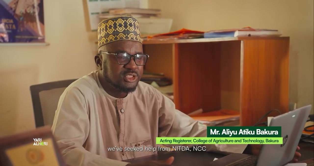 A college representative discusses ICT support in Bakura. Film still.