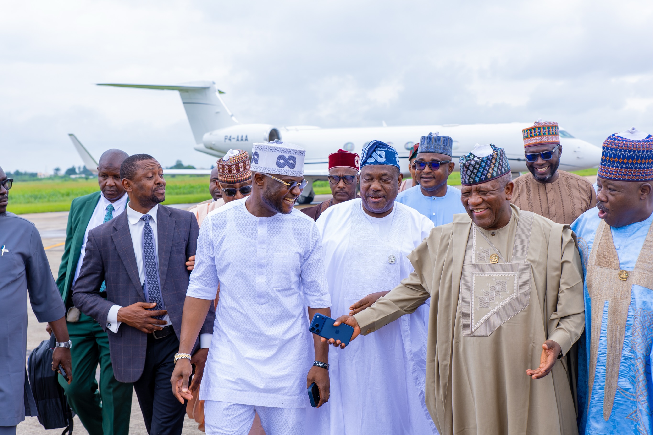 Senator Abdulaziz Yari walks with members of the visiting delegation on the airport apron.