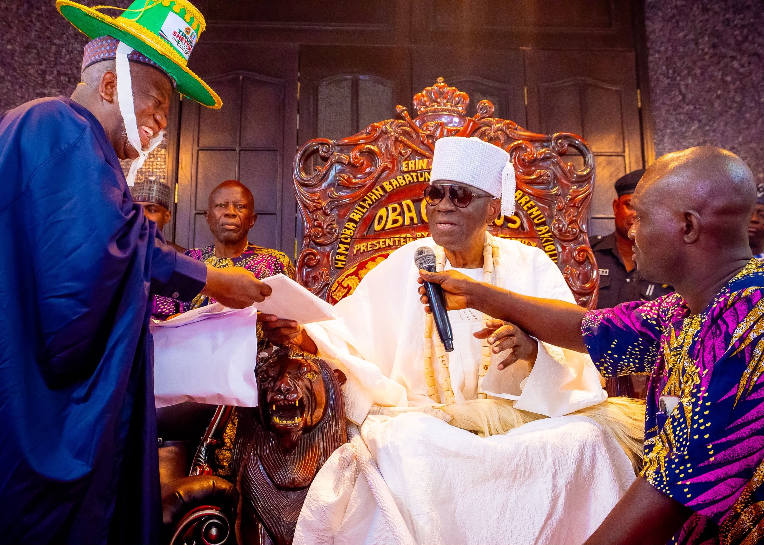 Senator Yari presents a document during the audience with the Oba of Lagos.