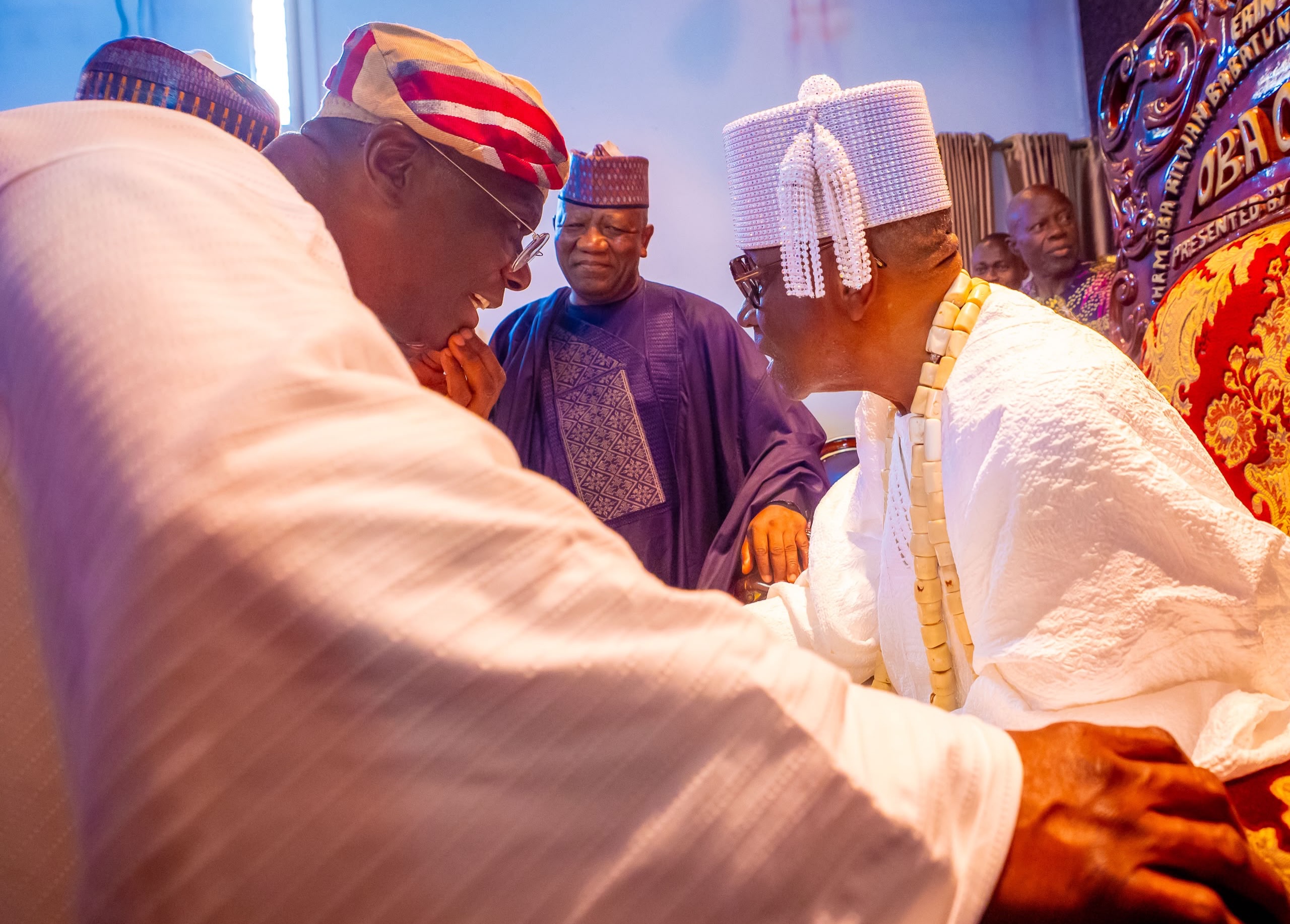 A greeting during the palace audience with the Oba of Lagos.