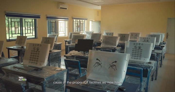 A college representative discusses ICT support in Bakura. Film still.