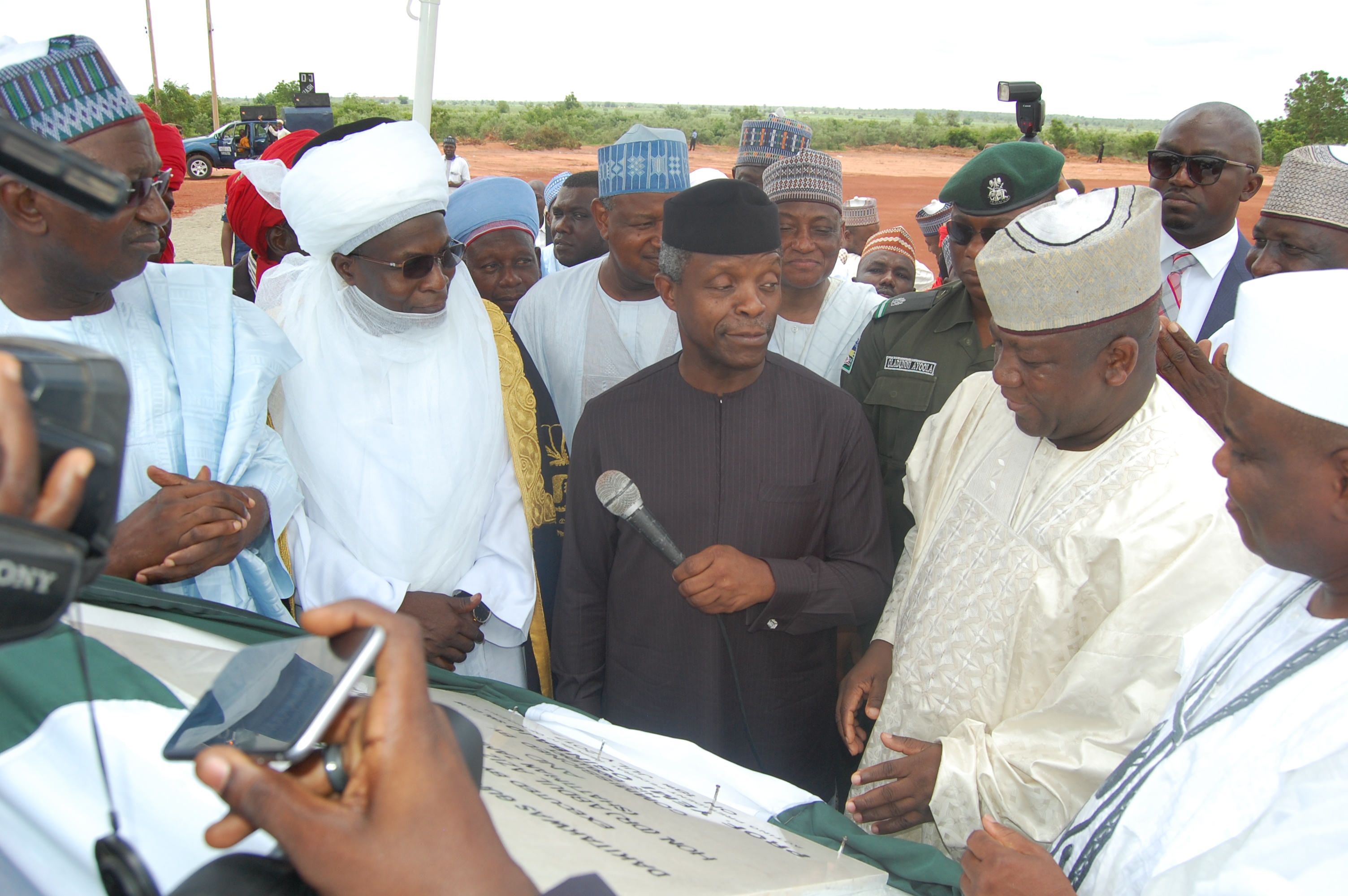 Vice President Osinbajo and Governor Yari at a project plaque with other participants.